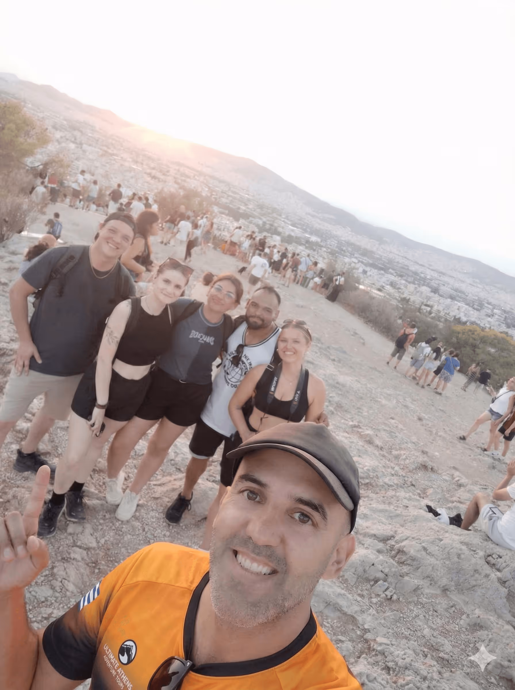 Small group enjoying 360-degree summit views on an Athens city walking tour