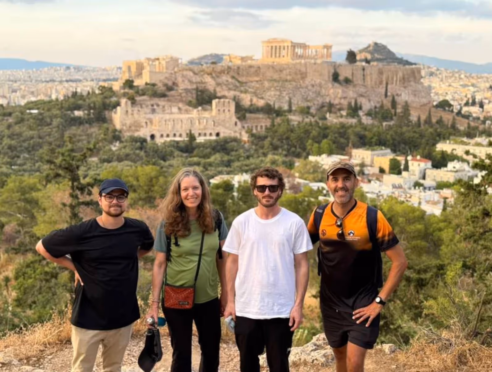 George with a small group of guests watching the sunrise from an Athens hilltop at first light