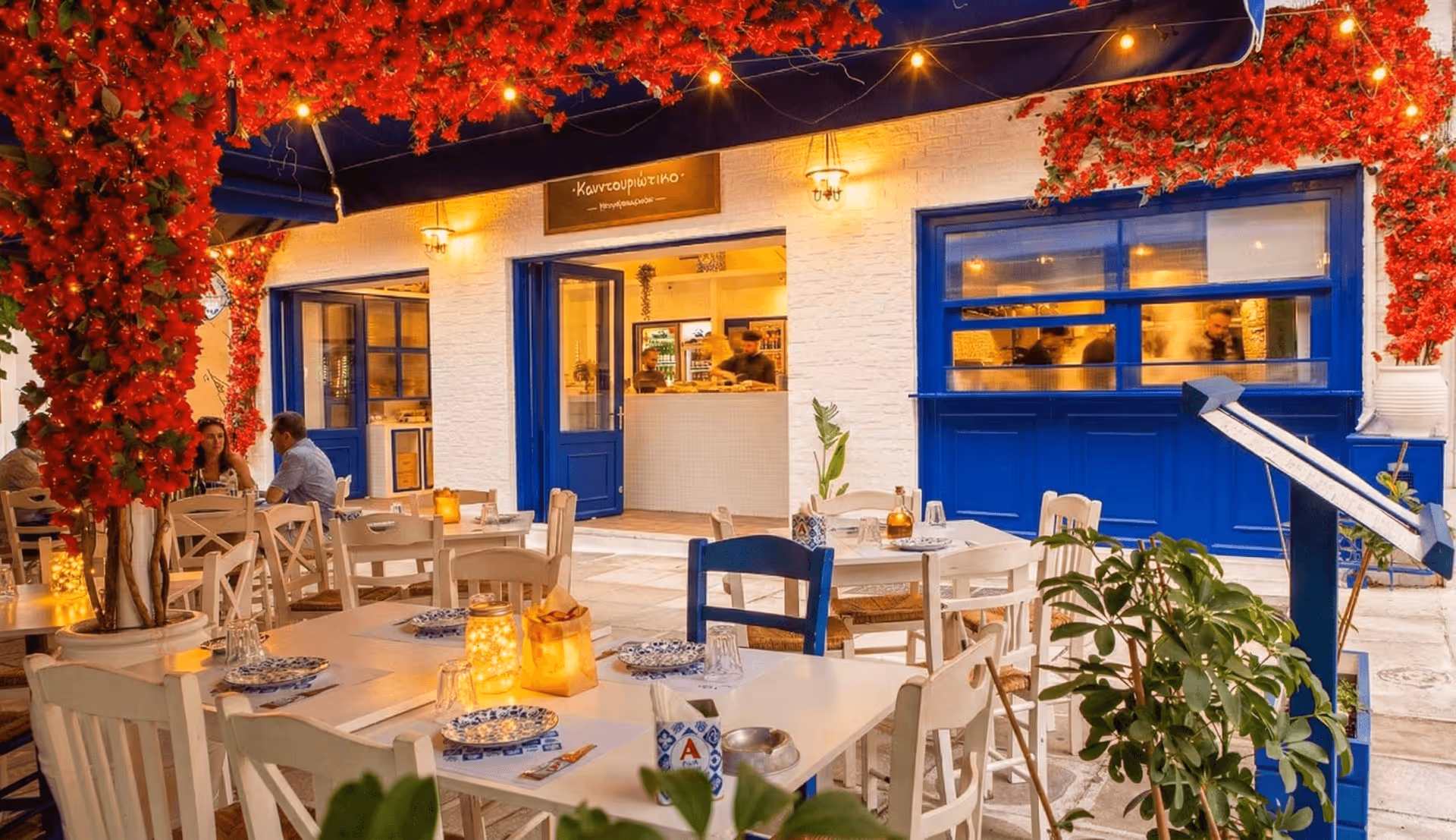 Kountouriotiko restaurant in Koukaki, Athens — blue framed taverna with bougainvillea and outdoor tables